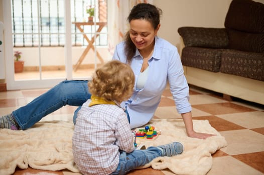 A joyful interaction between mother and child, enjoying quality time together at home, celebrating the happiness of motherhood and parent-child bonding.