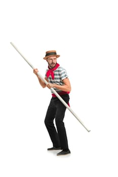 Caucasian funny bearded man in traditional gondolier costume and hat with paddle standing and looking away at studio isolated on white background. Serious young man. Human emotions, facial expression concept