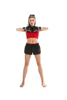 Young active beautiful woman with the black boxing gloves boxing at studio isolated on white background. Fitness, boxing concept. Female boxer. Human emotions. Caucasian model. head blow energy