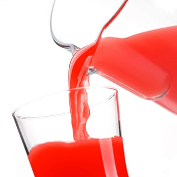 Pouring delicious tomato or strawberry red juice in a glass, healthy drinks concept