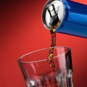Pouring a refreshing sugary soft drink from a can into a glass