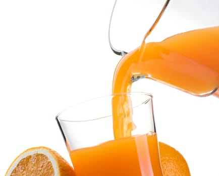 Pouring refreshing natural orange juice into a glass: nutrition and healthy drinks