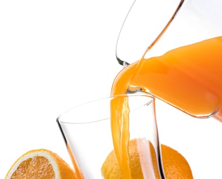 Pouring refreshing natural orange juice into a glass: nutrition and healthy drinks
