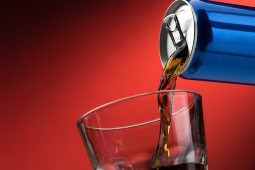 Pouring a refreshing sugary soft drink from a can into a glass