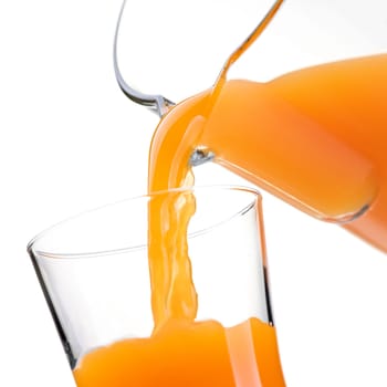 Pouring refreshing natural orange juice into a glass: nutrition and healthy drinks