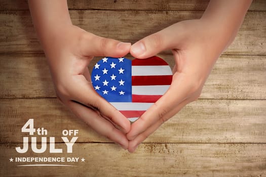 Human hands make a heart shape with american flag inside it. Happy Independence Day