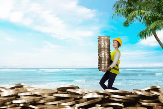 Pretty asian workers bringing coin stacks. Summer saving concept