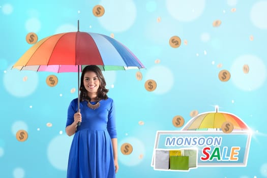 Beautiful asian woman holding umbrella with rainy gold coin. Monsoon sale concept
