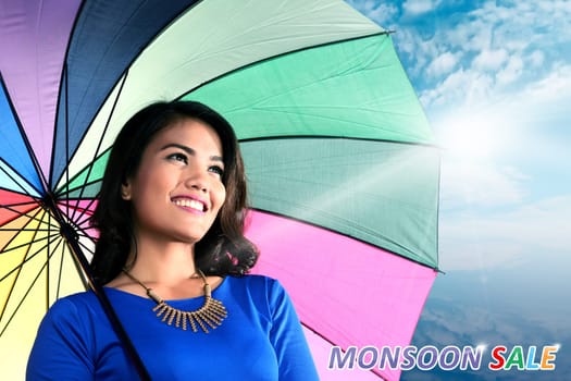 Smiling asian woman with umbrella. Monsoon sale concept