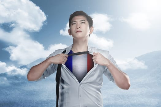 Handsome asian businessman ripped his shirt off and showing france flag color. Happy Bastille Day