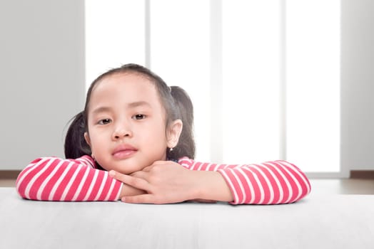 Excited asian children with relax lean on the table at home
