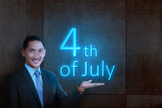 Young asian businessman showing glowing light of 4th of July. Independence day 4th of July