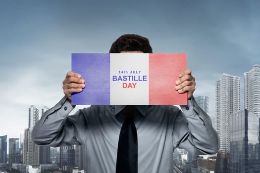 Businessman holding france flag with Bastille Day text. Happy Bastille Day