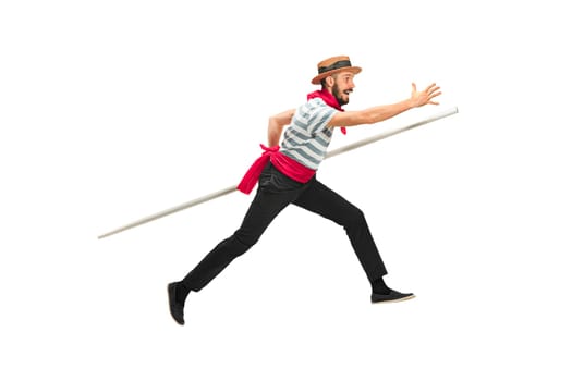 Caucasian funny bearded man in traditional gondolier costume and hat with paddle wide-reaching or jumping at studio isolated on white background. Humor. Human emotions, facial expression concept