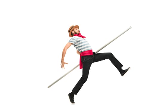 Caucasian funny bearded man in traditional gondolier costume and hat with paddle wide-reaching or jumping at studio isolated on white background. Humor. Human emotions, facial expression concept