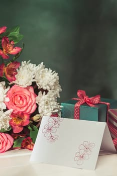 Love background with pink roses, flowers, gift, card on table. Concept of holiday Mother's Day. Copy space. Colorful studio background. holiday congratulations concept. Mother and love. Postcard
