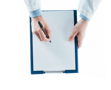 Doctor writing a prescription on a clipboard on white background, top view, hands close up