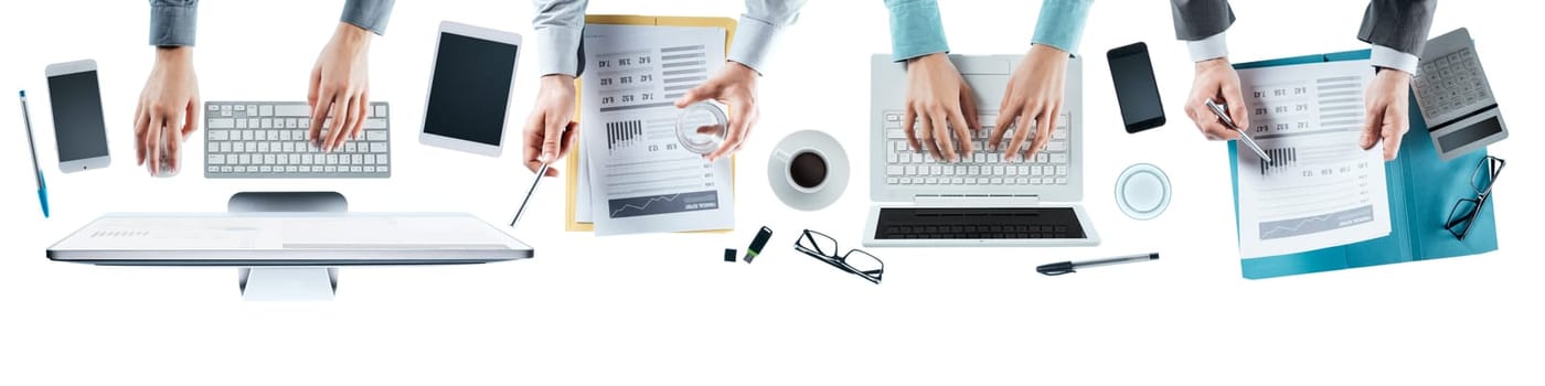 Business team working at office desk top view, blank copy space, unrecognizable people