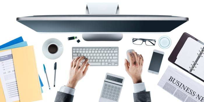 Businessman working at computer at office desk, top view