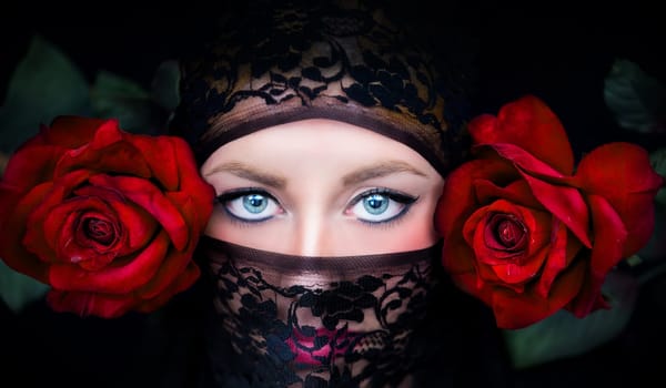 Close-up of a veiled woman with blonde hair and blue eyes