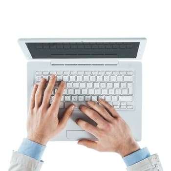 Businessman working at computer and typing on a laptop keyboard, top view, hands close up