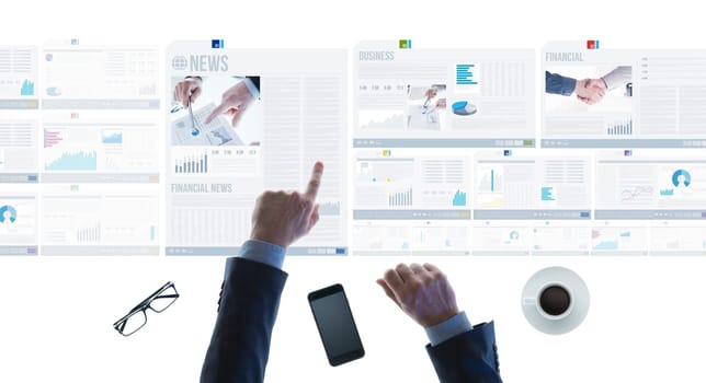 Professional businessman pointing at financial reports and scrolling news slides on a touch screen light desk, hands close up
