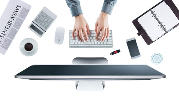 Business woman working at office desk and typing on a keyboard, white background, hands top view