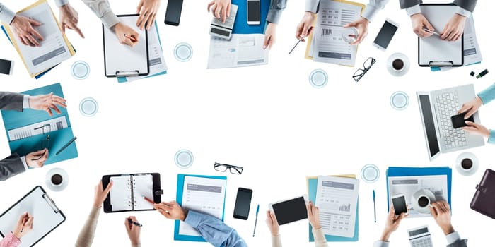 Business team meeting and working at office desk, hands top view, unrecognizable people, blank copy space