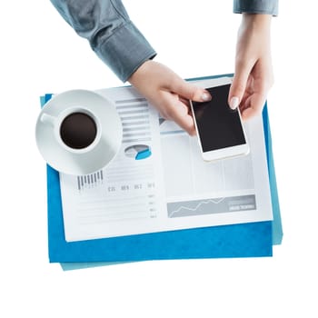 Business woman working at desk and using a touch screen smart phone, hands close up