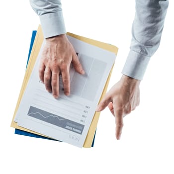 Businessman holding a financial report and pointing on white background, hands close up, top view