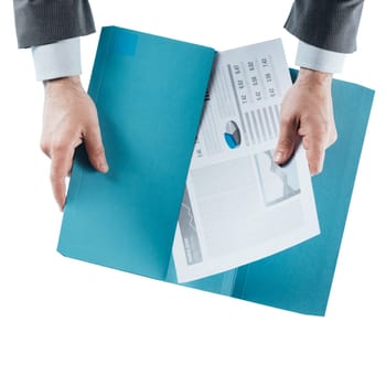 Businessman holding a financial report in a folder, hands close up, top view
