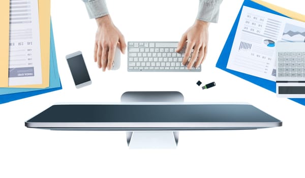 Businessman working at office desk and using a computer, hands top view, white background