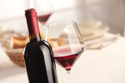 Red wine glass and bottle still life at restaurant.