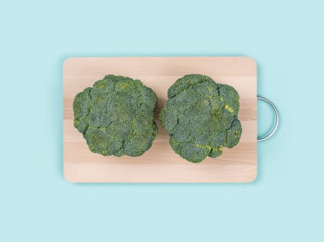 Fresh broccoli on a wooden chopping board, food preparation and healthy eating concept