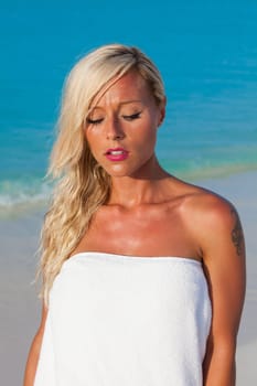 Young blonde girl sunbathing on sunbeds