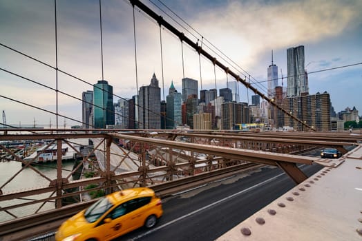 Brooklyn Bridge, New York, United States - June 08, 2015: Panoramic views from brooklyn bridge, skyscrapers and passing cars, the Manhattan skyline.