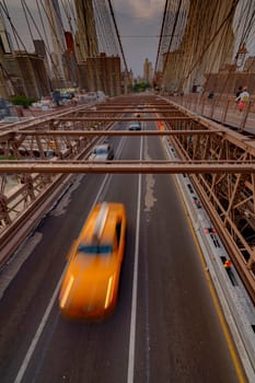 Brooklyn Bridge, New York, United States - June 08, 2015: Panoramic views from brooklyn bridge, skyscrapers and passing cars, the Manhattan skyline.