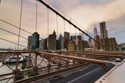 Brooklyn Bridge, New York, United States - June 08, 2015: Panoramic views from brooklyn bridge, skyscrapers and passing cars, the Manhattan skyline.