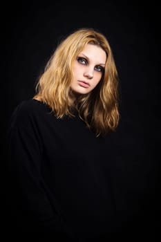 Portrait of a girl on a black background with bright makeup