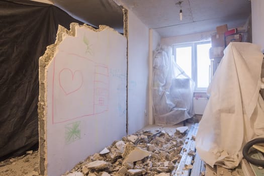 Reshaping the apartment. Dismantling of walls. Things are covered with a cloth for protection from dust