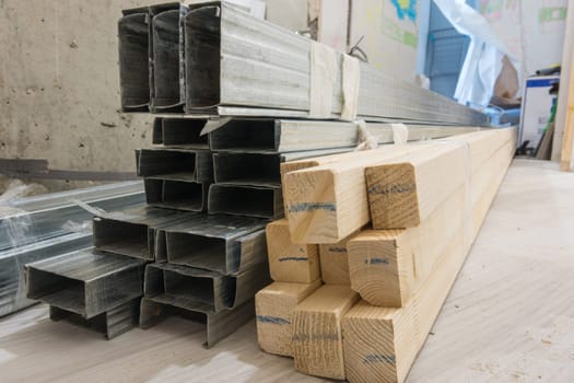 Building materials - wooden bars and metal profiles, on the floor in the apartment