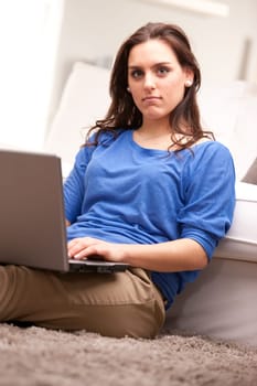 this beautiful self confident girl uses her notebook in relax in her living room