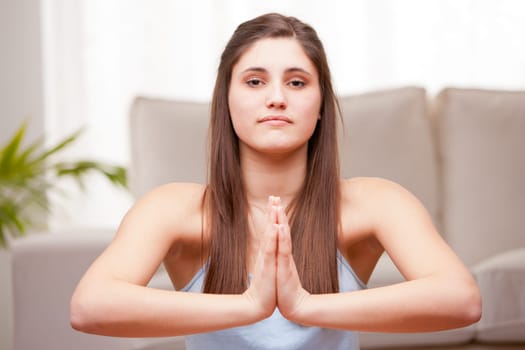 young woman preparing for her yoga exercises