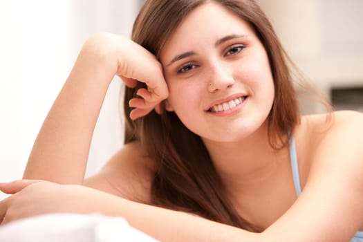 beautiful girl smiling shy on her sofa in her shiny living room