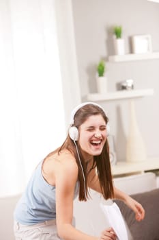 girl with an irrepressible laugh listening to music and singing out loud because she's happy