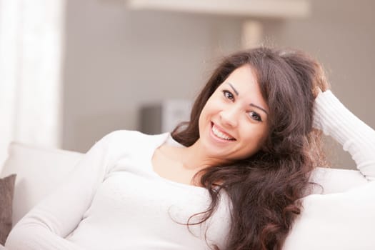 this Italian brunette has big brown eyes and is softly relaxing on this white living room waiting for your AD to be completed