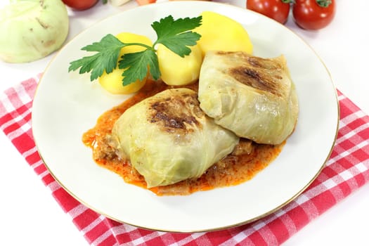 a plate of cabbage roulade and potatoes