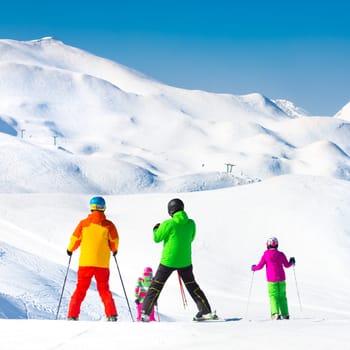 Family on winter ski vacations in ski slopes in Alps, Vogel, Slovenia, Europe.