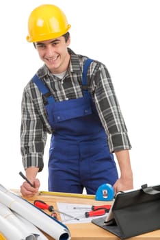 a worker measuring a board with a tape measure