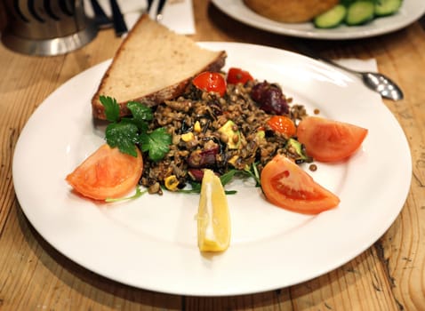 Lentils on a plate with vegetables photographed closeup